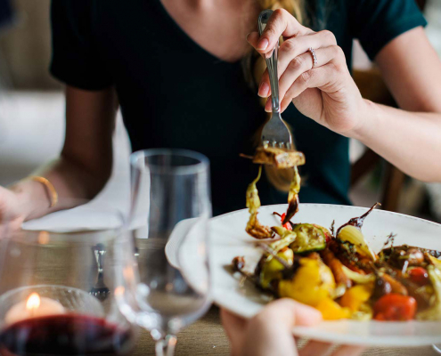 Close up of a woman eating a meal.