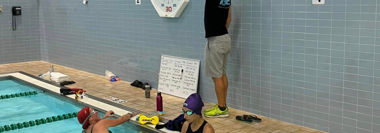 Grit Endurance Coach Jim instructing swimmers at the pool