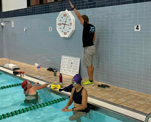 Grit Endurance Coach Jim instructing swimmers at the pool