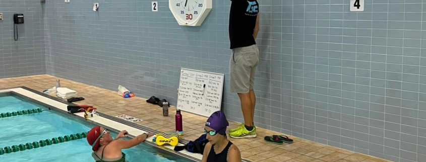 Grit Endurance Coach Jim instructing swimmers at the pool