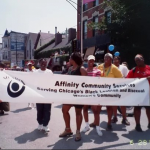 Group from Affinity Community Service holding a banner outside
