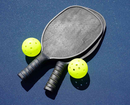 a picture of pickleball rackets on a pickleball court