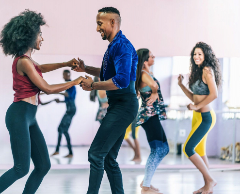 Couples learning how to salsa dance