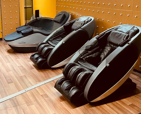 Photo of 2 massage chairs and cryotherapy bed