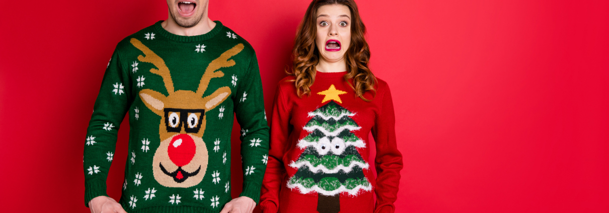 Two people wearing ugly Christmas sweaters