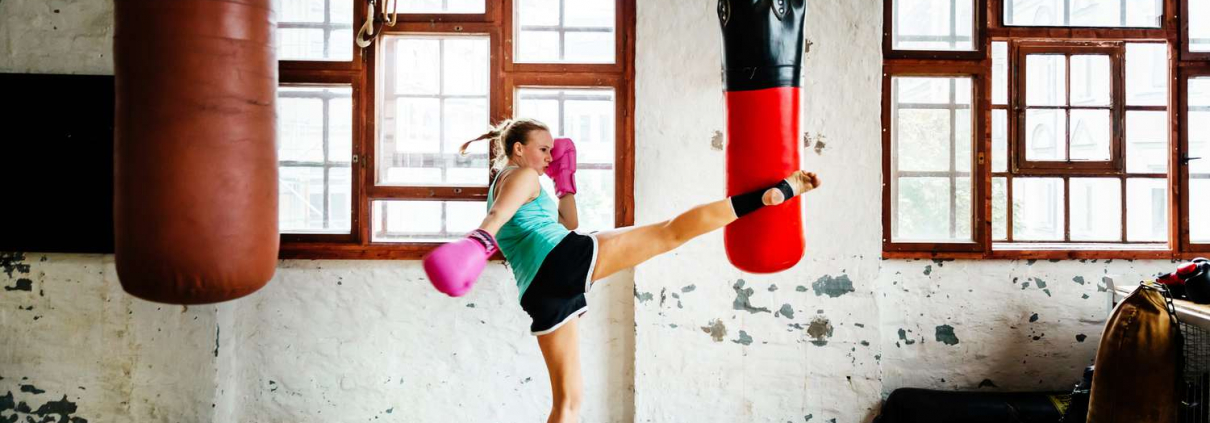 A women practicing kickboxing in a gym