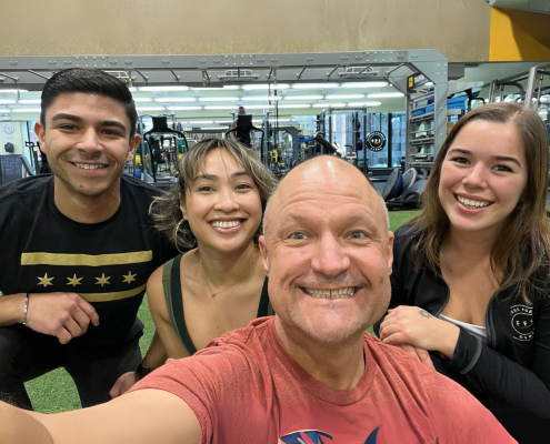 four members taking a selfie on the turf