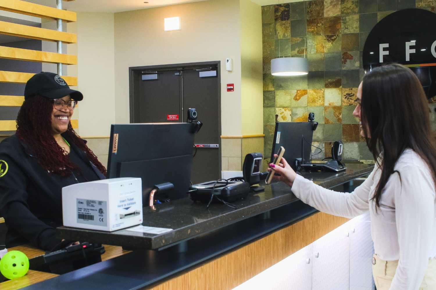 member checking in being greeted by front desk