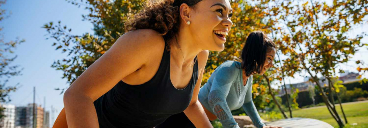 Two women participating in an outdoor workout