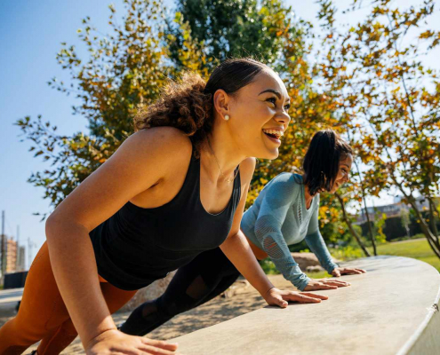 Two women participating in an outdoor workout