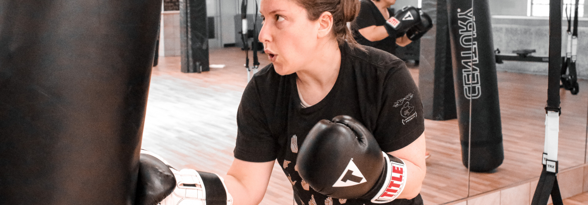 Woman punching a punching bag at Chicago's best gym