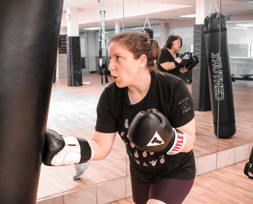 Woman punching a punching bag at Chicago's best gym