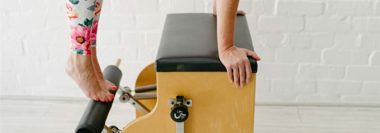 A women doing pilates on a Wunda Chair