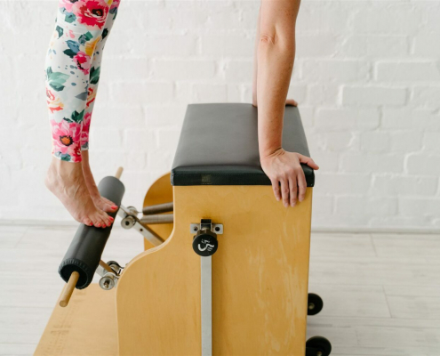 A women doing pilates on a Wunda Chair