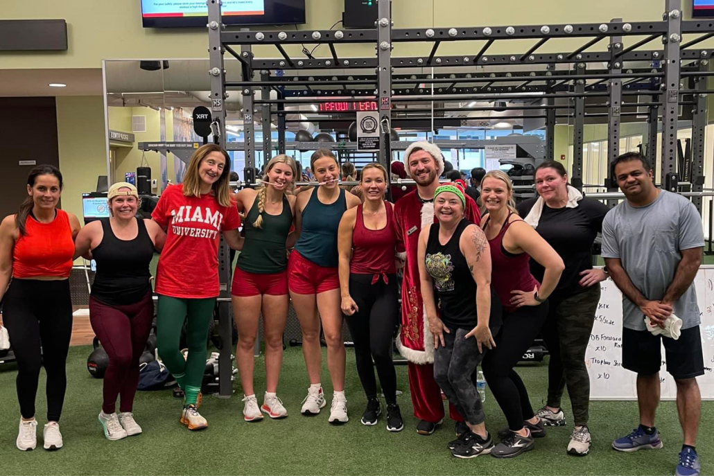 Christmas-themed group fitness HIIT class on the turf at Elmhurst Gym.