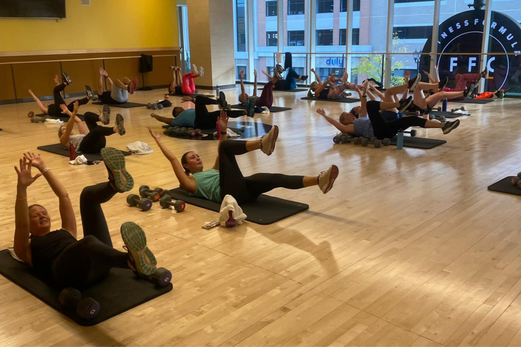 Group fitness HIIT class in studio at Elmhurst Gym.