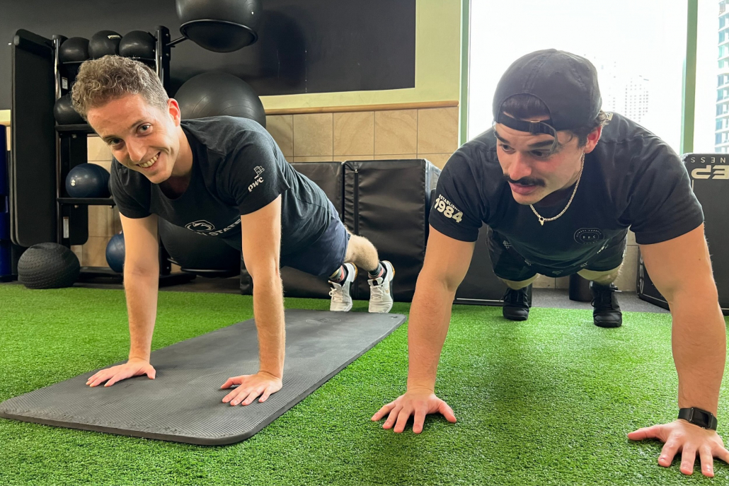 Personal Trainer teaching proper plank form at Gold Coast Gym.