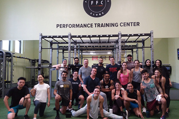 Group performance training class on the turf at Old Town Chicago Gym.