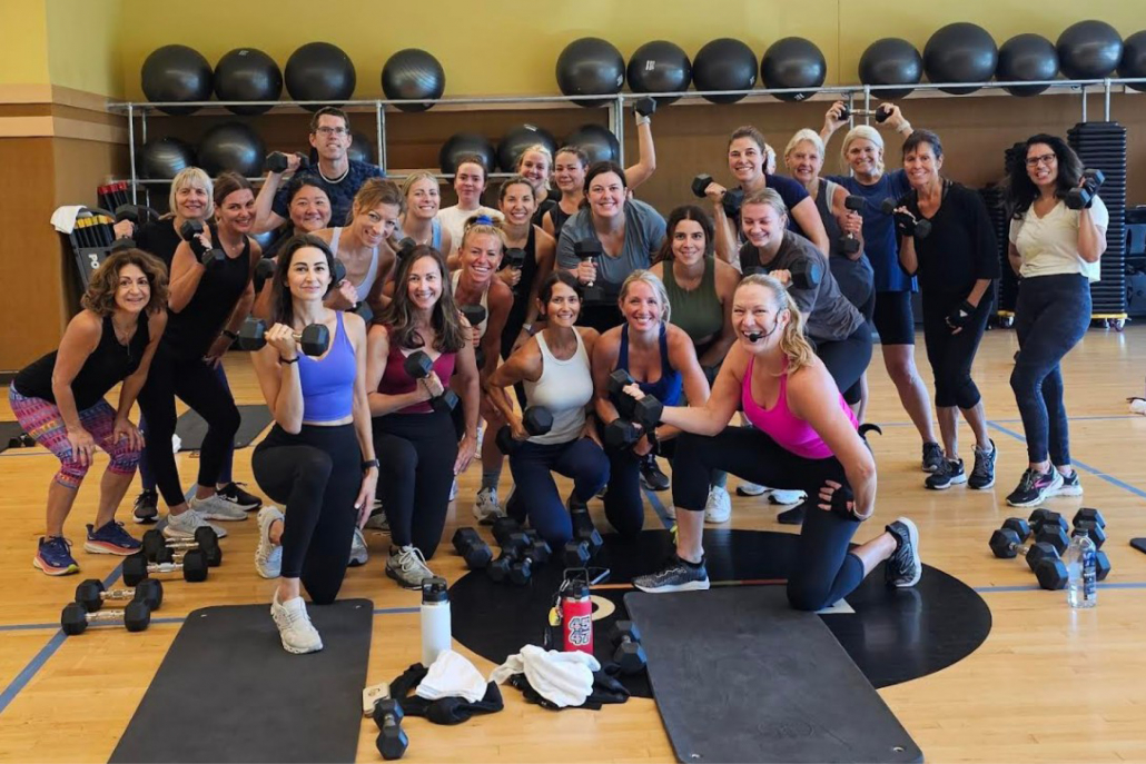 Group fitness class with weights in the studio at Best Gym in Park Ridge.