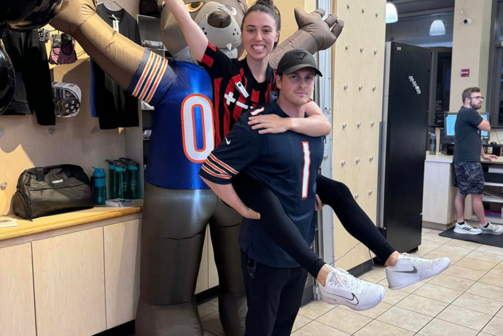 Staff members posing with Chicago Bears blow up Mascot.