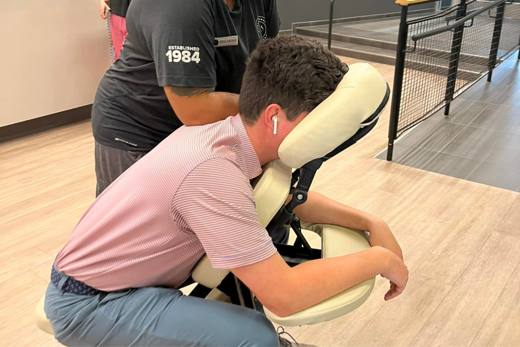 Member getting a chair massage at Best Gym in Chicago.