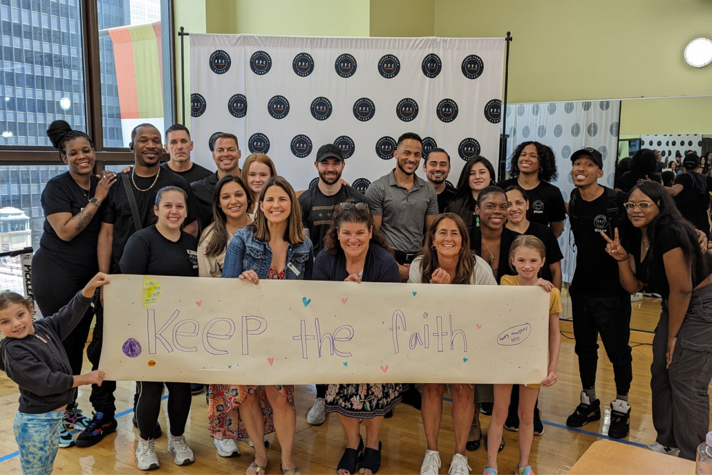 Group posing with Keep The Faith sign at Best Gym in Chicago.