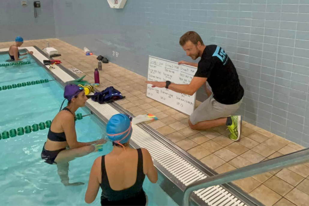 Swim coach training members in indoor pool at FFC Union Station.