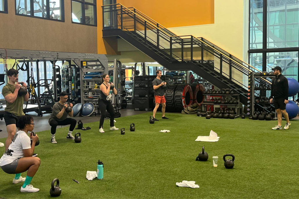 Group fitness class on the indoor turf at Union Station gym.