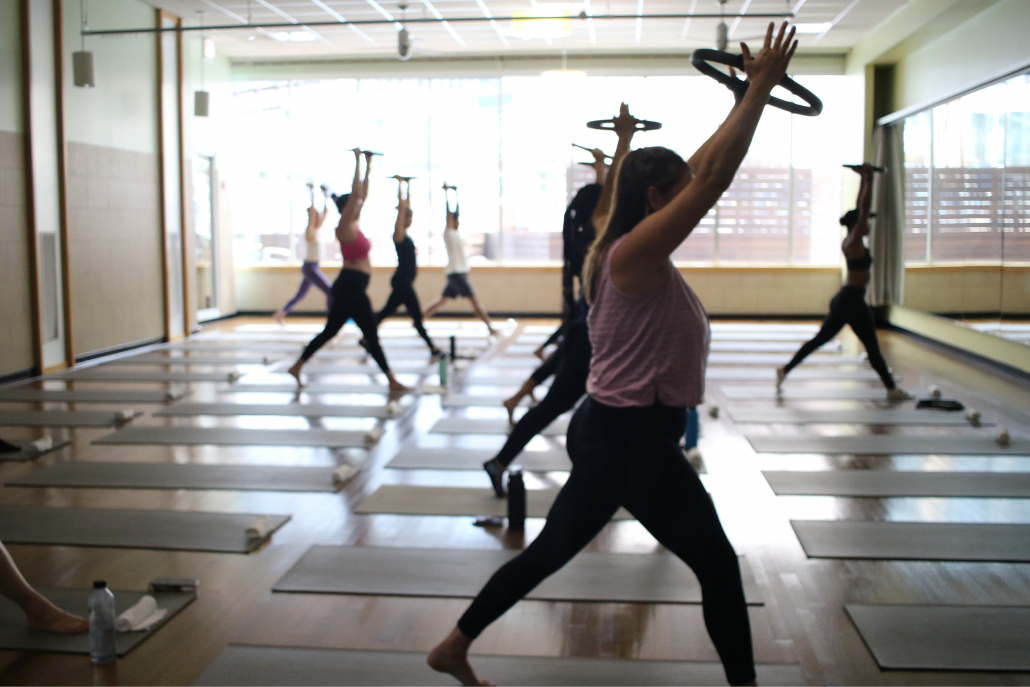 Members in a Pilates Mat class in the mind body studio.