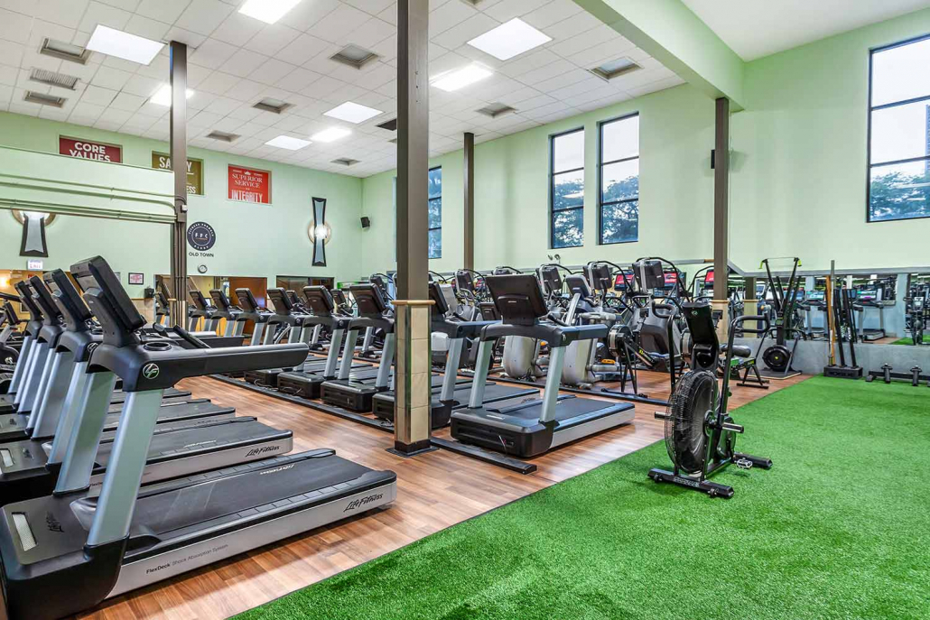 Cardio floor with treadmills and spin bikes at Old Town Chicago gym.