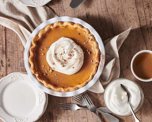 A pumpkin pie on a table