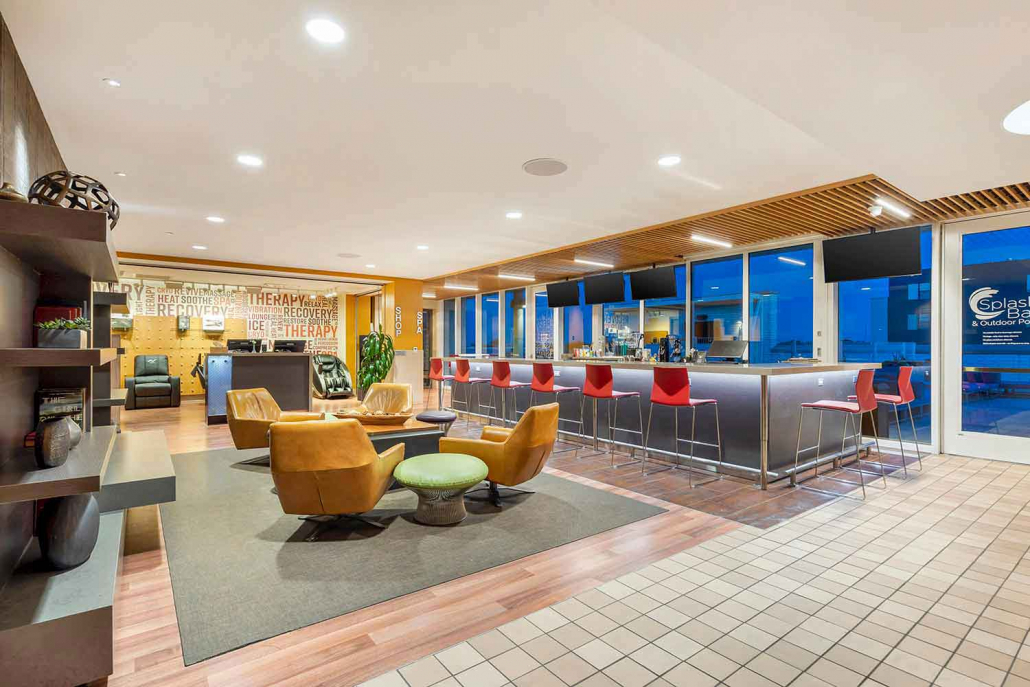 Club Lounge with full-service bar, fireplace and seating area inside Elmhurst Gym.