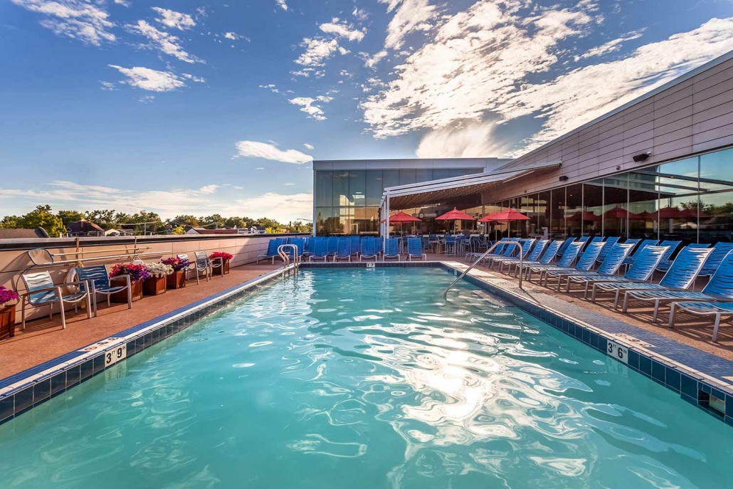 Outdoor pool with splash bar at sunset at Park Ridge Gym.