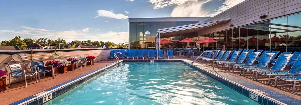 Outdoor pool with splash bar at sunset at Park Ridge Gym.