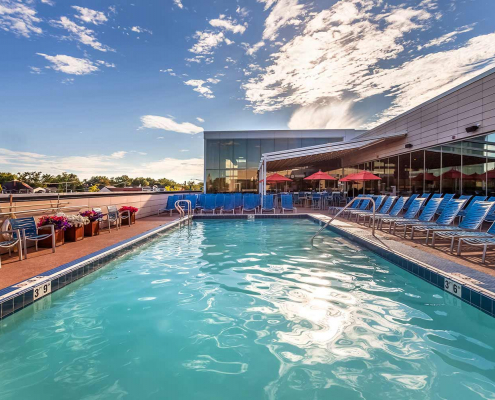 Outdoor pool with splash bar at sunset at Park Ridge Gym.