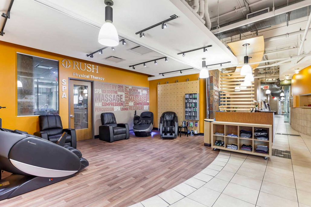 Recovery lounge with massage chairs and cryo chairs inside Oak Park Gym.