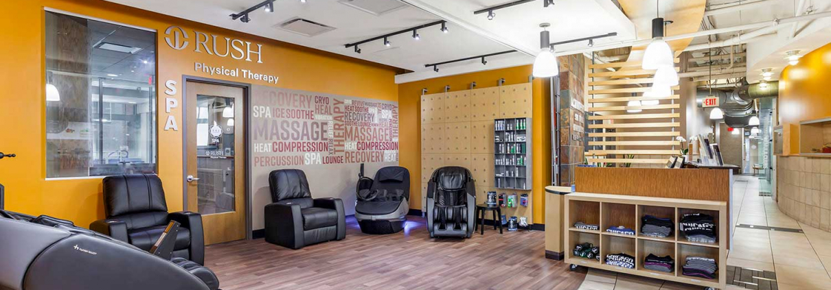 Recovery lounge with massage chairs and cryo chairs inside Oak Park Gym.