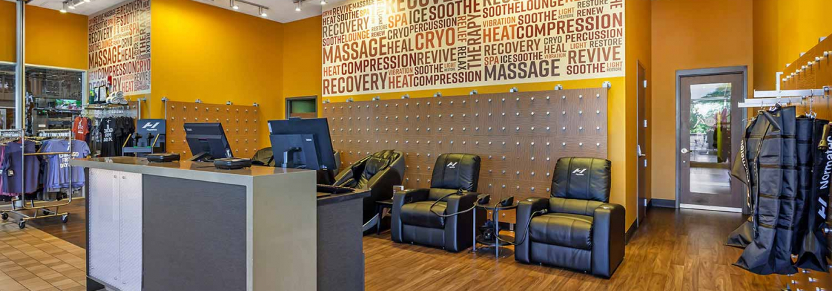 Recovery lounge with massage chairs and cryo chairs inside Park Ridge Gym.