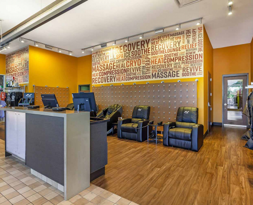 Recovery lounge with massage chairs and cryo chairs inside Park Ridge Gym.