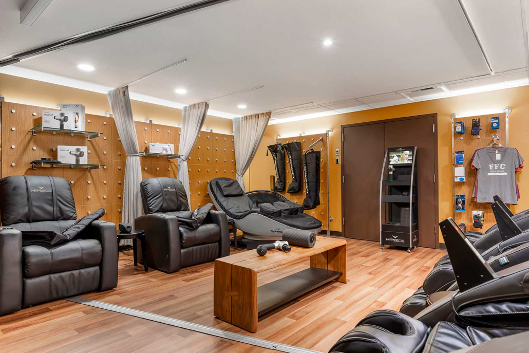 Recovery lounge with massage chairs and cryo chairs inside FFC Gold Coast Gym.