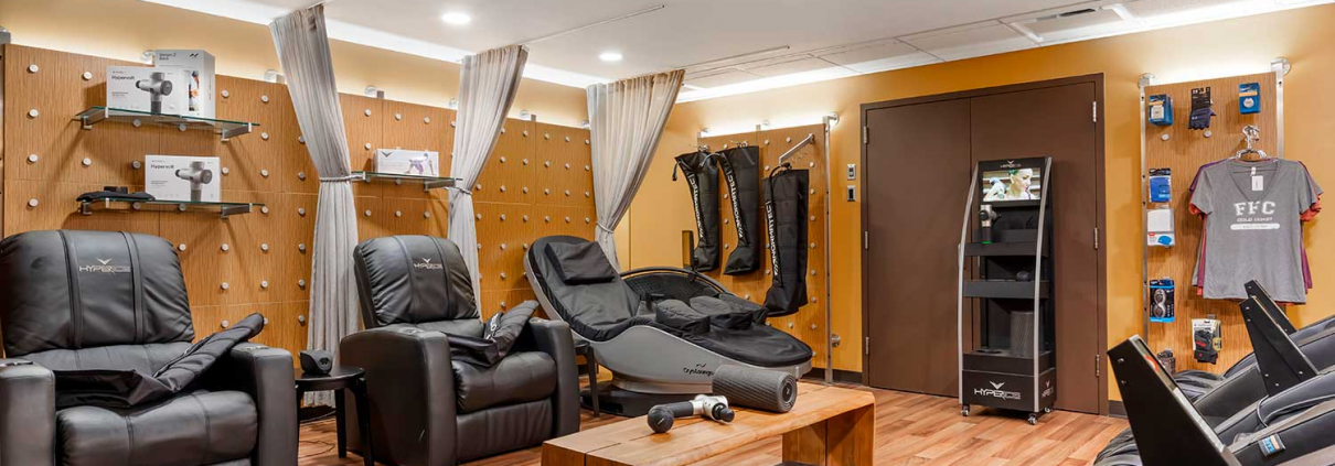 Recovery lounge with massage chairs and cryo chairs inside FFC Gold Coast Gym.