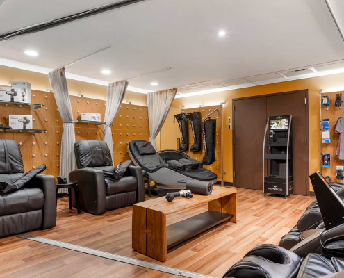 Recovery lounge with massage chairs and cryo chairs inside FFC Gold Coast Gym.