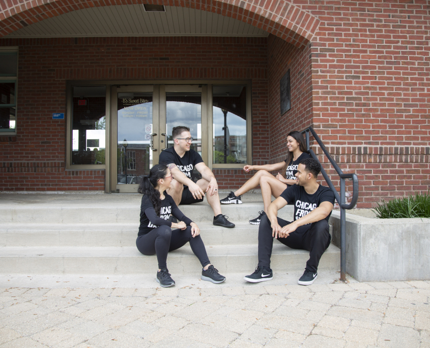 Personal Trainers sitting on stairs by FFC Park Ridge community building.jpg