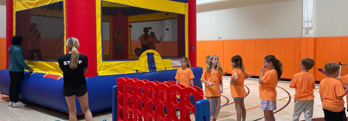 Kids club at FFC Park Ridge. Kids waiting in line for the bouncy house