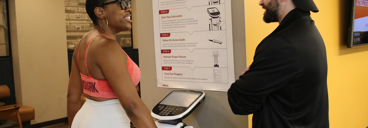 FFC personal trainer assisting member on in body machine at FFC Union Station.