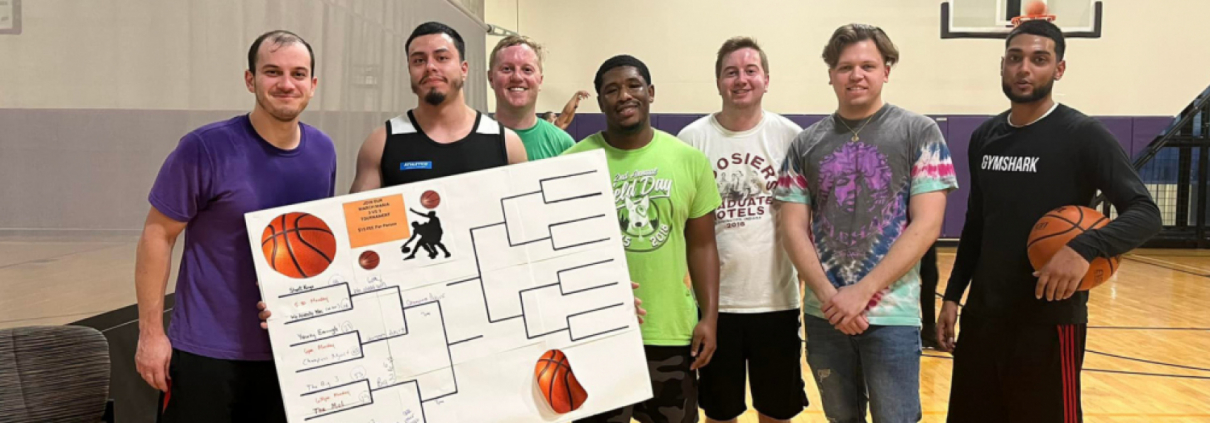 Group of FFC Union Station Members playing basketball with their scorecard for tournaments.