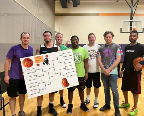 Group of FFC Union Station Members playing basketball with their scorecard for tournaments.