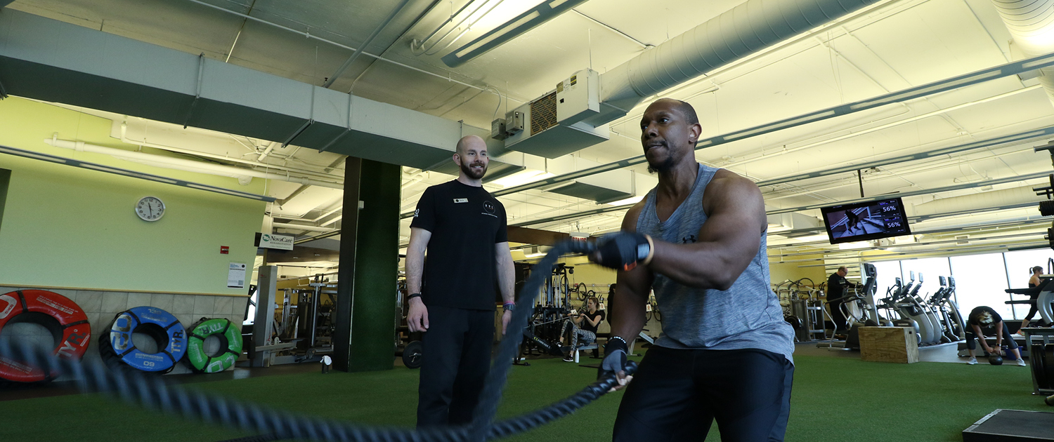 Personal Trainer assisting client at FFC Lincoln Park
