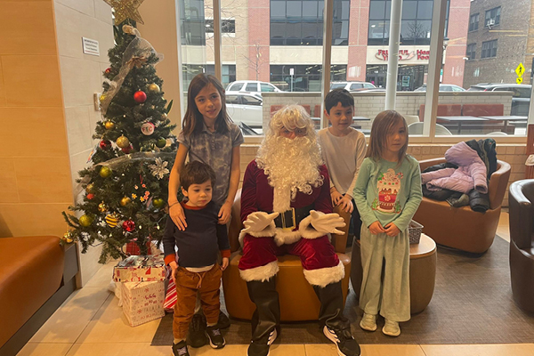 FFC Elmhurst Kids Club Members with Santa Claus in the Club Lounge
