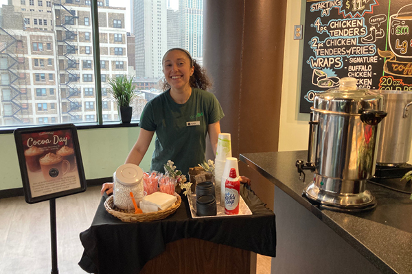 ffc Gold Coast local'84 cafe employee with a hot cocoa set up promoting their club hot cocoa day